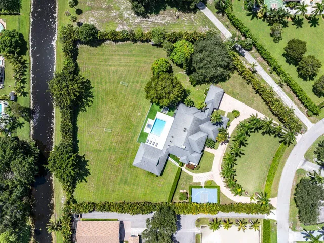 an aerial view of residential house with outdoor space and swimming pool