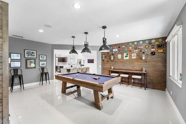 a living room with furniture a flat screen tv and a table