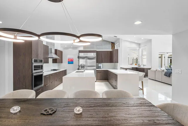 a living room with furniture and a view of kitchen