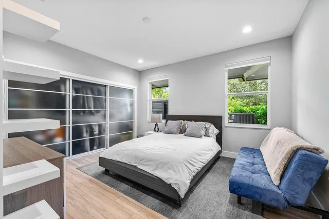 a bedroom with a bed window and walk in closet