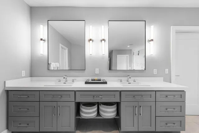 a bathroom with a double vanity sink and a mirror