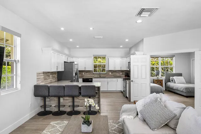 a living room with furniture kitchen and a window