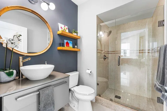 a bathroom with a toilet a sink and a mirror