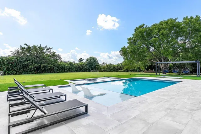 a view of a house with a backyard