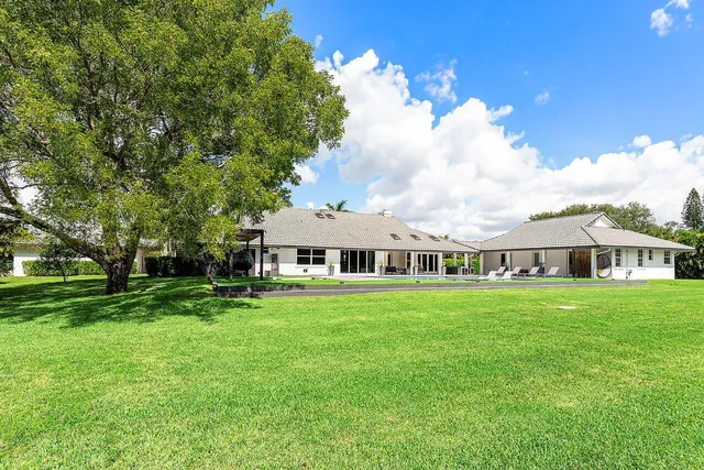 a aerial view of a house with swimming pool and a yard