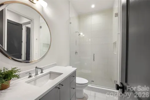 a hallway with a white stove top oven and wooden floor