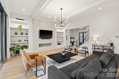 a dining room with furniture and a floor to ceiling window