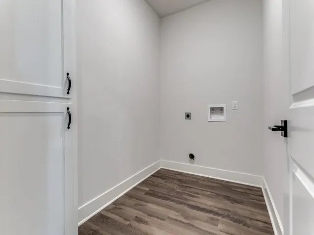 a view of a room with wooden floor