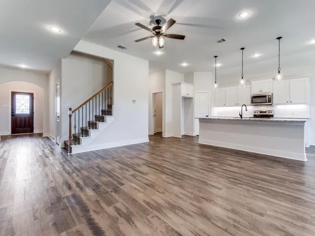 a view of kitchen and living room with wooden floor