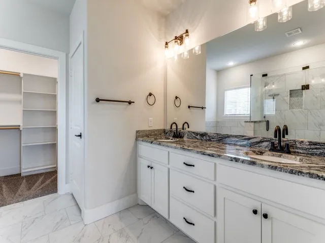 a bathroom with a granite countertop sink a mirror and a