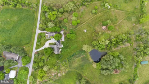 a view of a dining room with furniture a chandelier and wooden floor