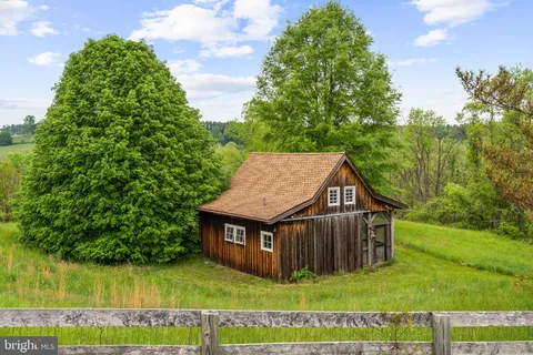 a view of a dining room with furniture a chandelier and wooden floor