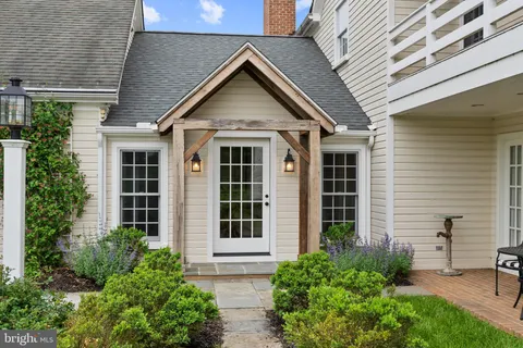 a view of a dining room with furniture wooden floor and a chandelier