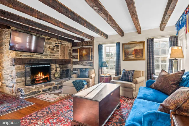 a living room with furniture fireplace and a large window