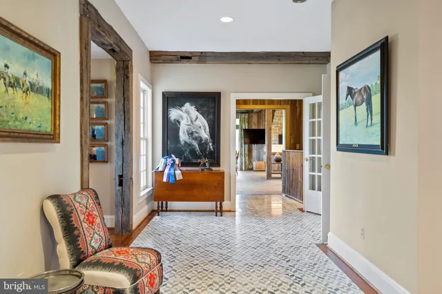 a living room with fireplace furniture and a large window