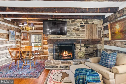 a view of a hallway to a livingroom with wooden floor windows and a livingroom