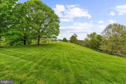 a living room with furniture a flat screen tv and a table