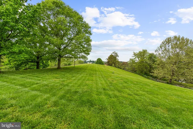 a living room with furniture a flat screen tv and a table