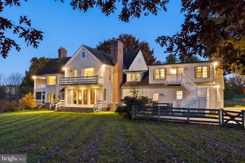 a view of a house with a yard porch and sitting area