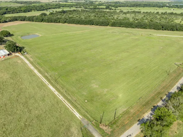 a view of a field with an ocean