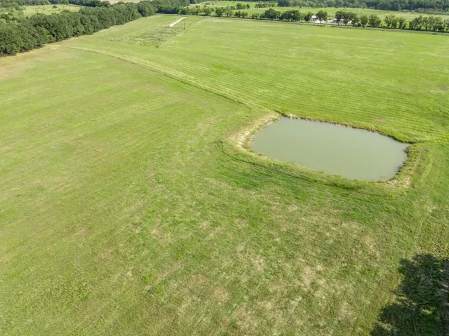 a view of a field with an ocean view