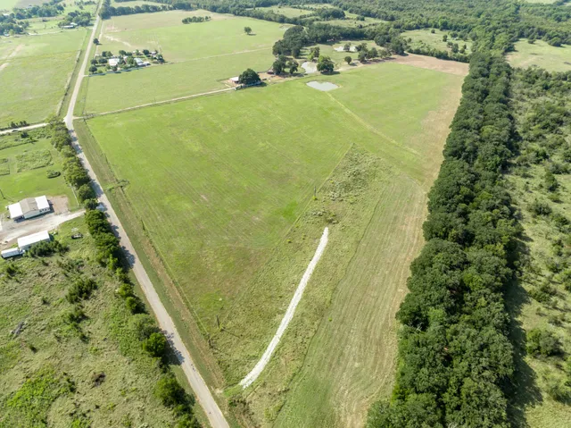 a view of a swimming pool with a yard