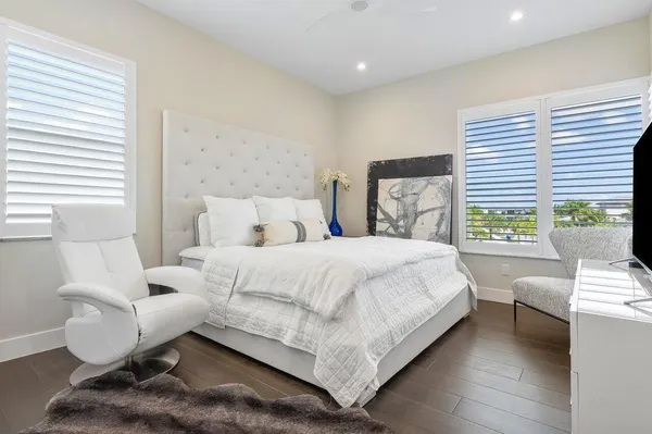 a bedroom with a bed and a large window