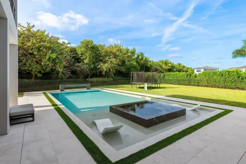 a view of swimming pool with chairs