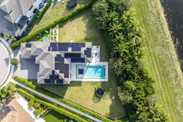 an aerial view of a house with a garden and swimming pool
