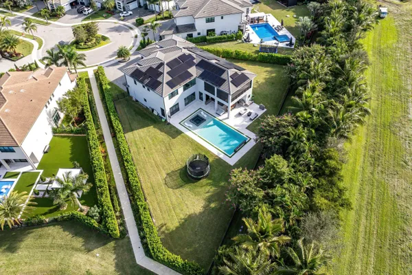 an aerial view of a house with a yard and potted plants