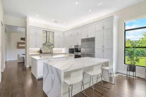 a kitchen with a table chairs refrigerator and microwave