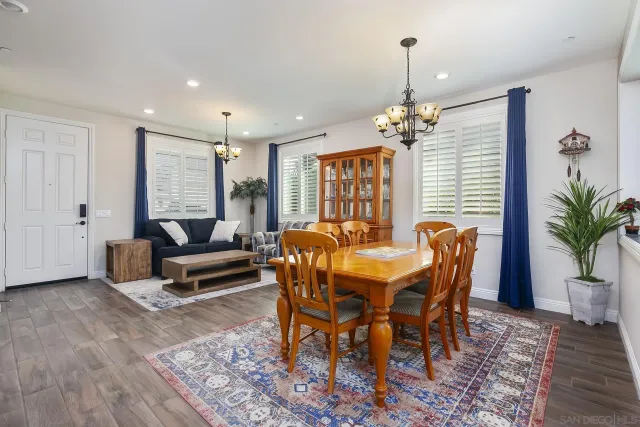 a view of a dining room with furniture and a chandelier
