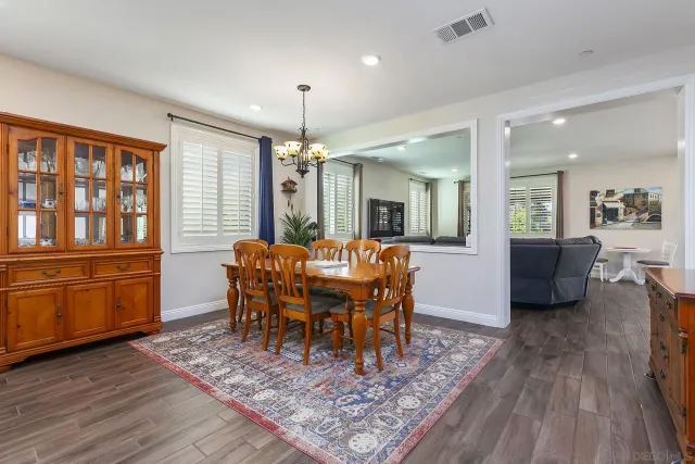 a dining room with furniture and wooden floor