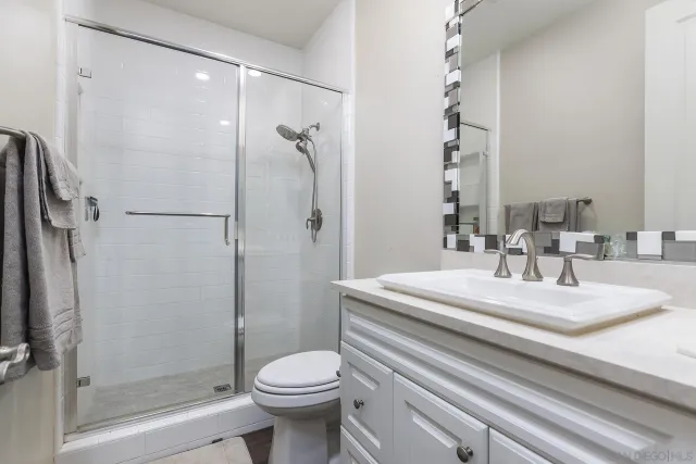 a spacious bedroom with a bed and a flat screen tv