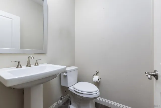 a bedroom with a bed and a lamp