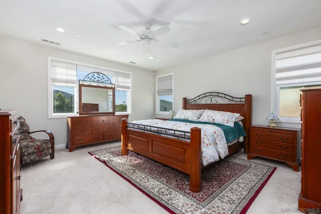 a en suite bathroom with a double vanity sink and a bathtub