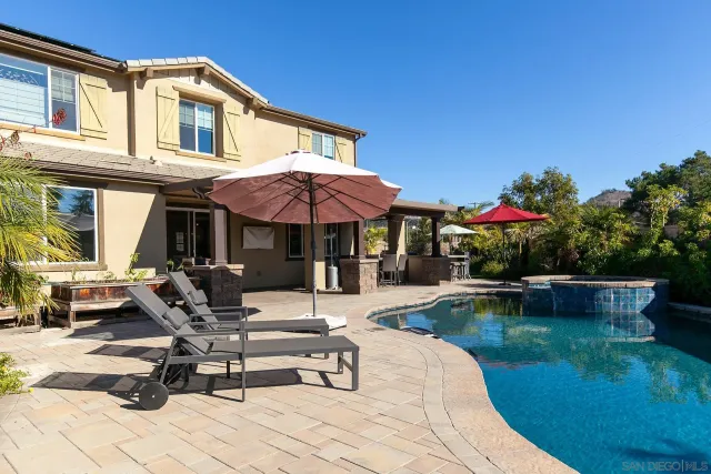 a view of a house with a yard and sitting area