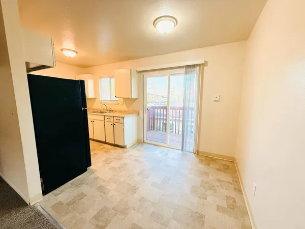 a view of a kitchen with a refrigerator and a stove