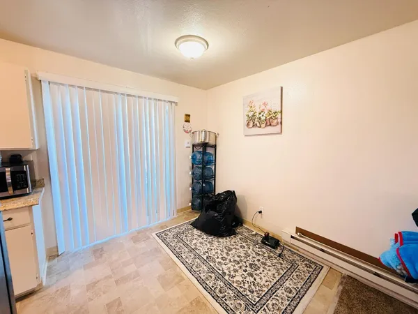 a view of a bedroom with a bed and a window