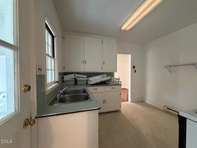 a kitchen that has a sink and a stove