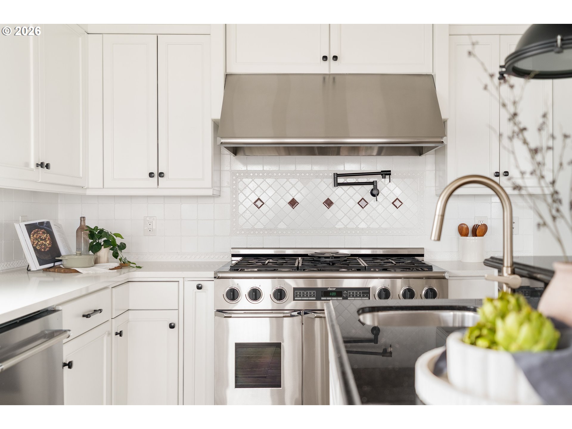 10230 Northwest Gloaming Lane Portland, OR 97229 - Photo 11 of 48 a kitchen with a stove and a white cabinets