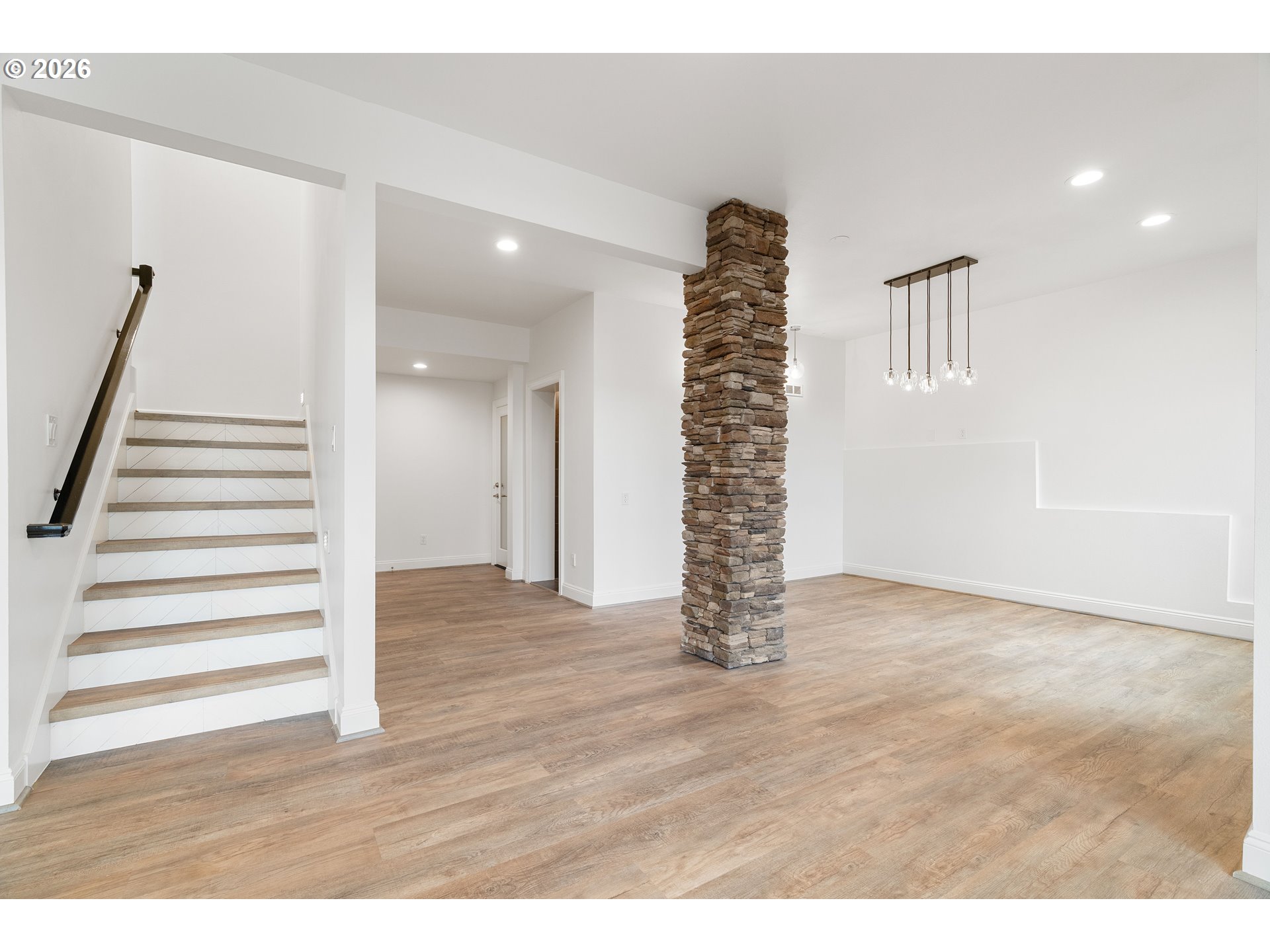 10230 Northwest Gloaming Lane Portland, OR 97229 - Photo 30 of 48 a view of an empty room with stairs and a window