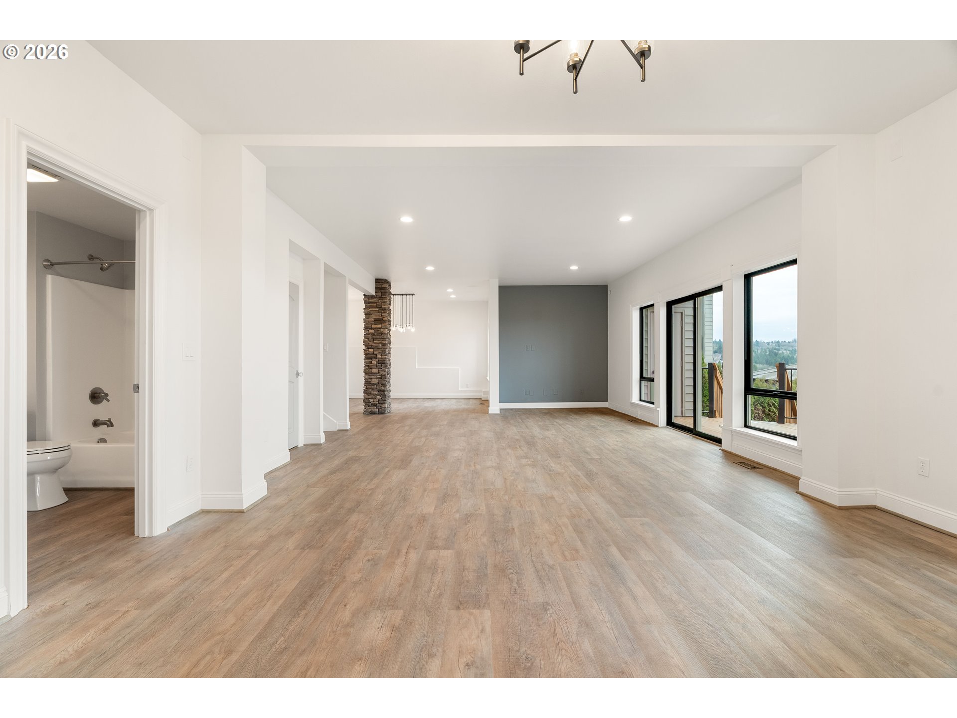 10230 Northwest Gloaming Lane Portland, OR 97229 - Photo 39 of 48 a view of an empty room with wooden floor and a window