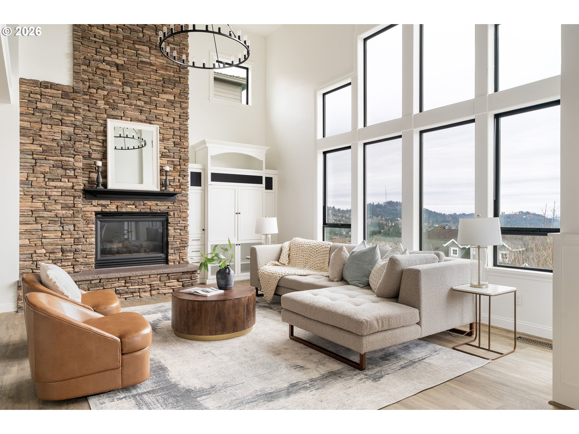 10230 Northwest Gloaming Lane Portland, OR 97229 - Photo 5 of 48 a living room with furniture a fireplace and a large window
