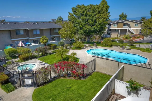 a view of a backyard with swimming pool