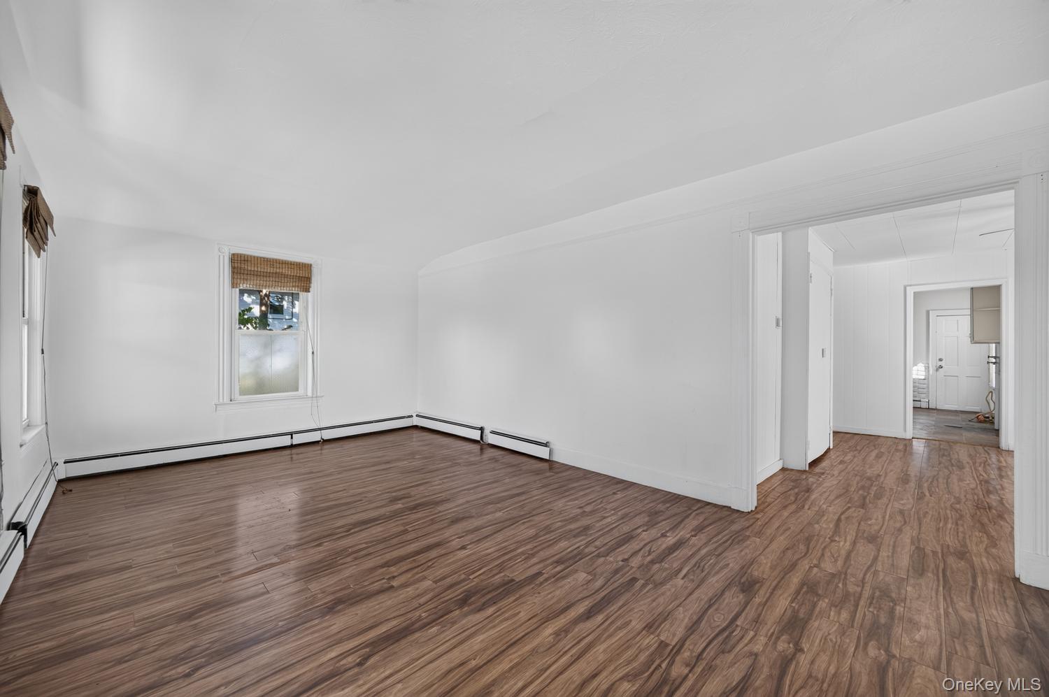49 Cedar Street Babylon, NY 11702 - Photo 5 of 20 a view of an empty room and wooden floor