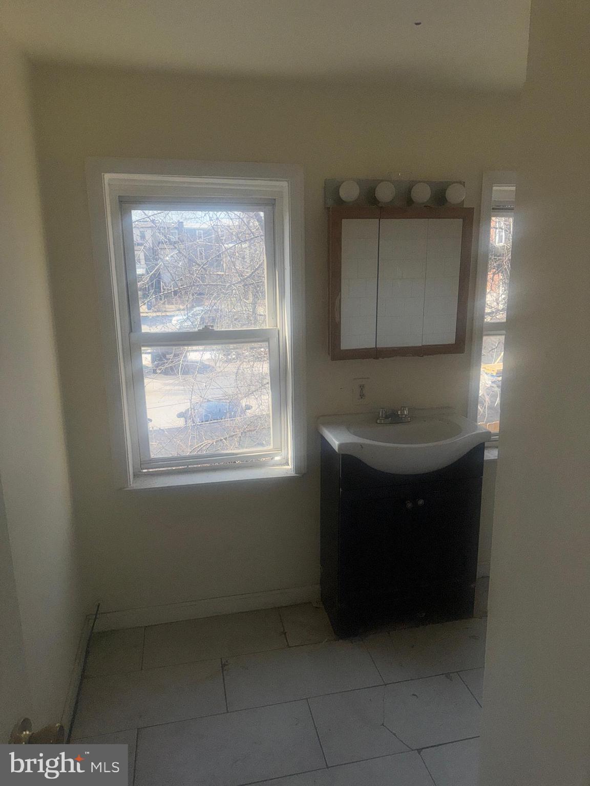 1022 North Gilmor Street Baltimore, MD 21217 - Photo 14 of 16 a bathroom with a sink and a mirror