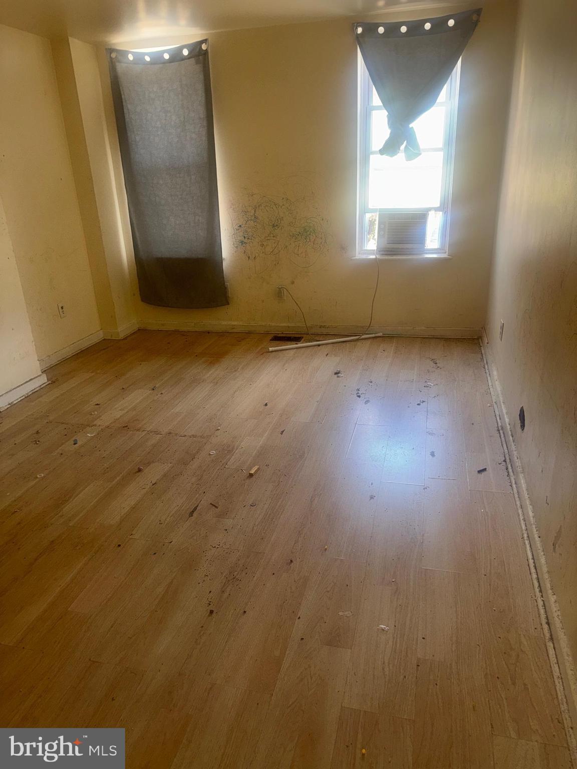 1022 North Gilmor Street Baltimore, MD 21217 - Photo 3 of 16 an empty room with wooden floor and windows