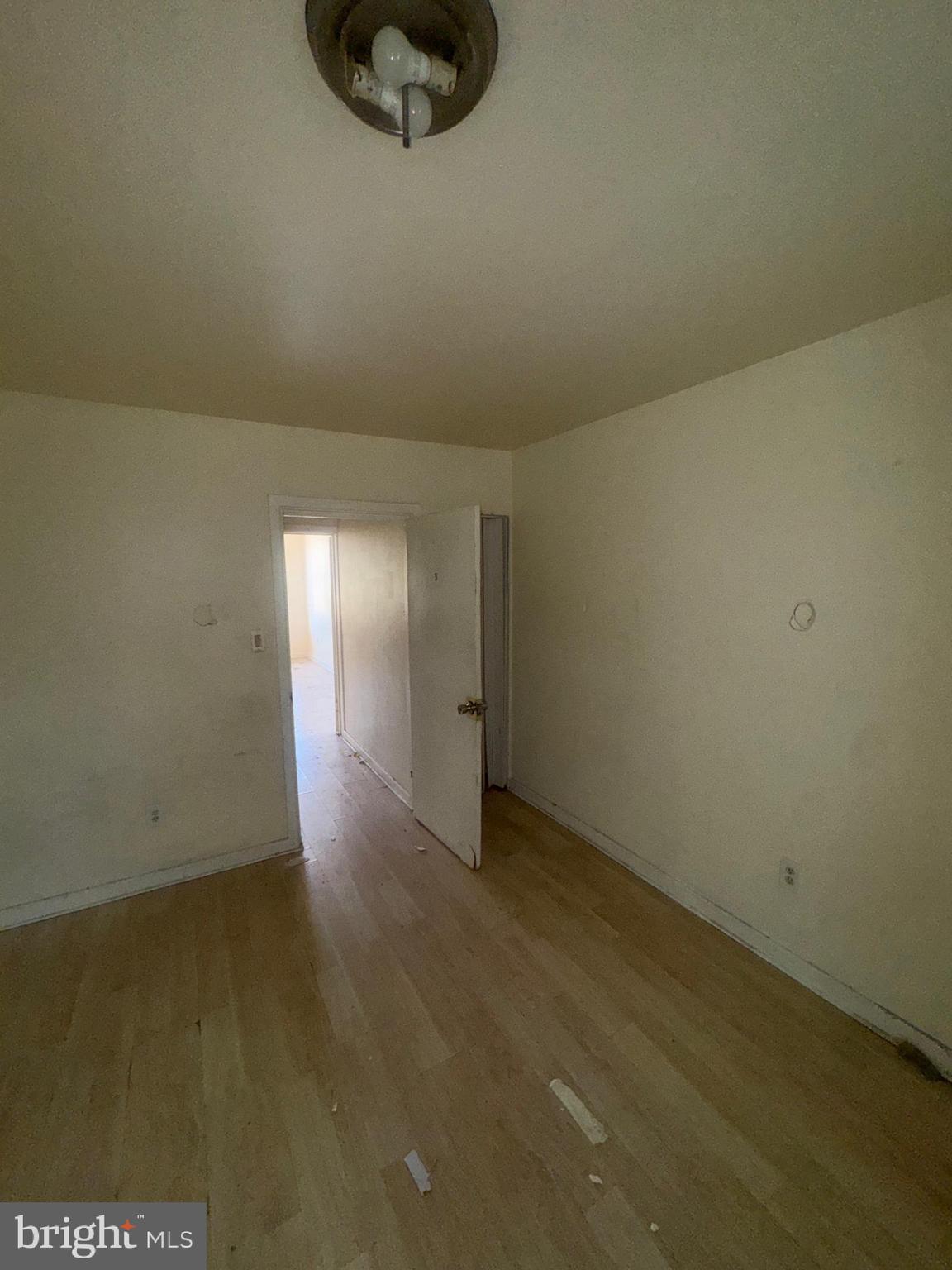 1022 North Gilmor Street Baltimore, MD 21217 - Photo 8 of 16 an empty room with wooden floor and windows