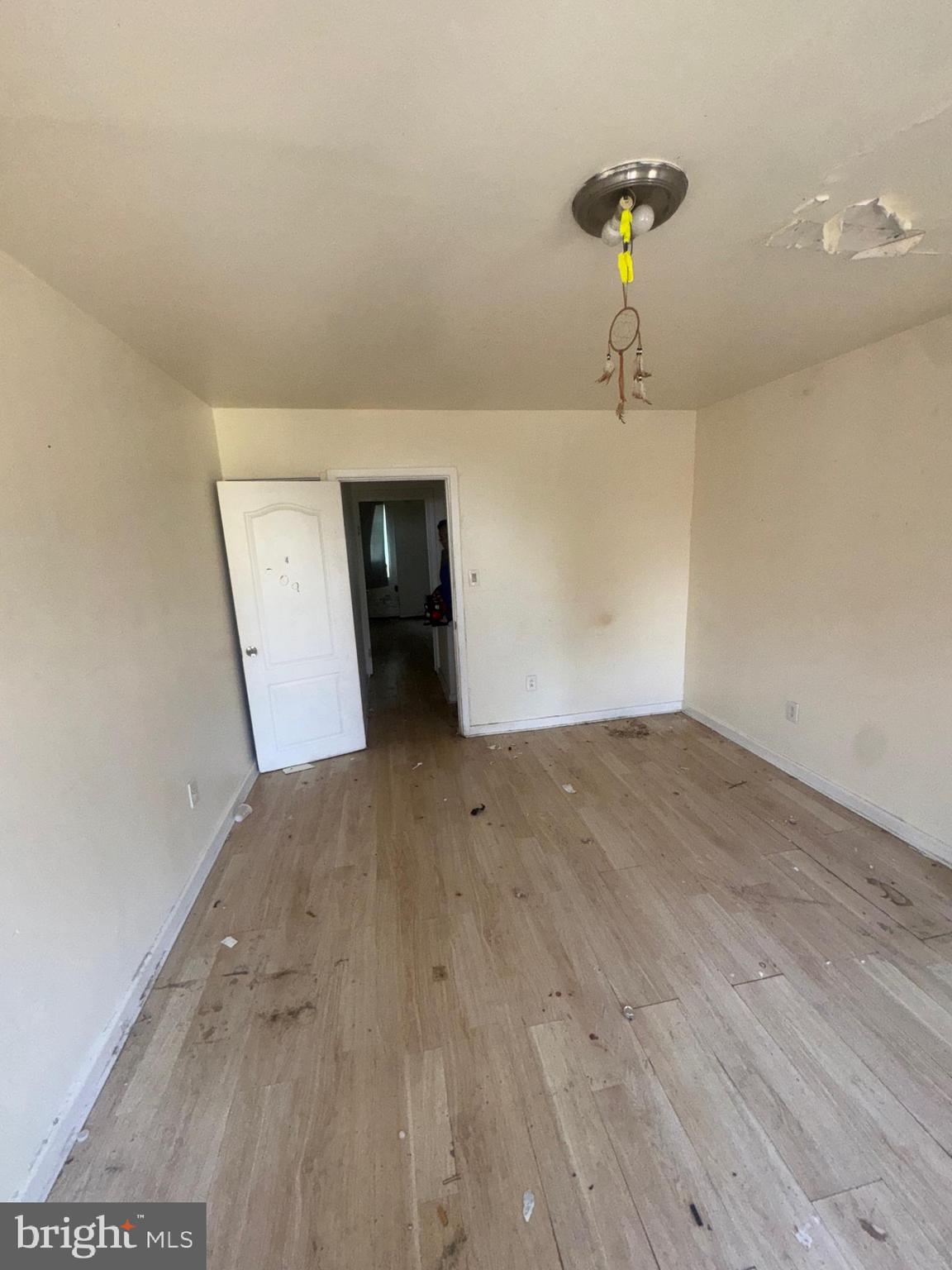 1022 North Gilmor Street Baltimore, MD 21217 - Photo 9 of 16 a view of a room with wooden floor and a ceiling fan